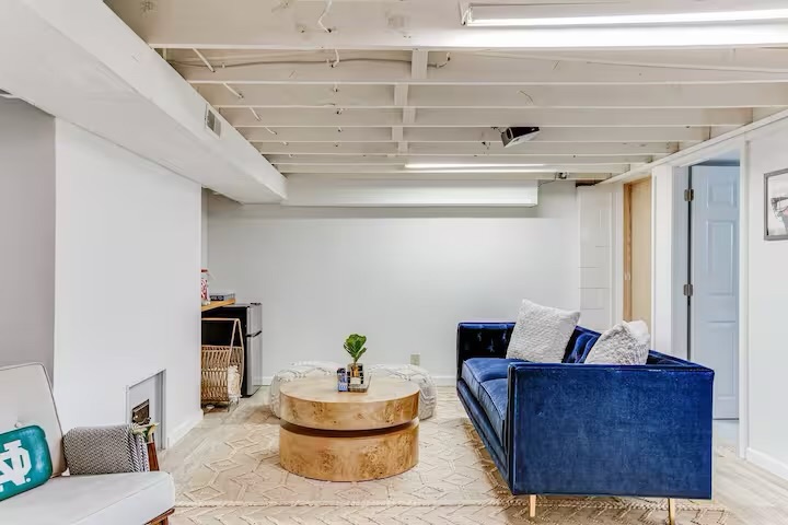 Basement movie theater lounge with Notre Dame pillow near campus